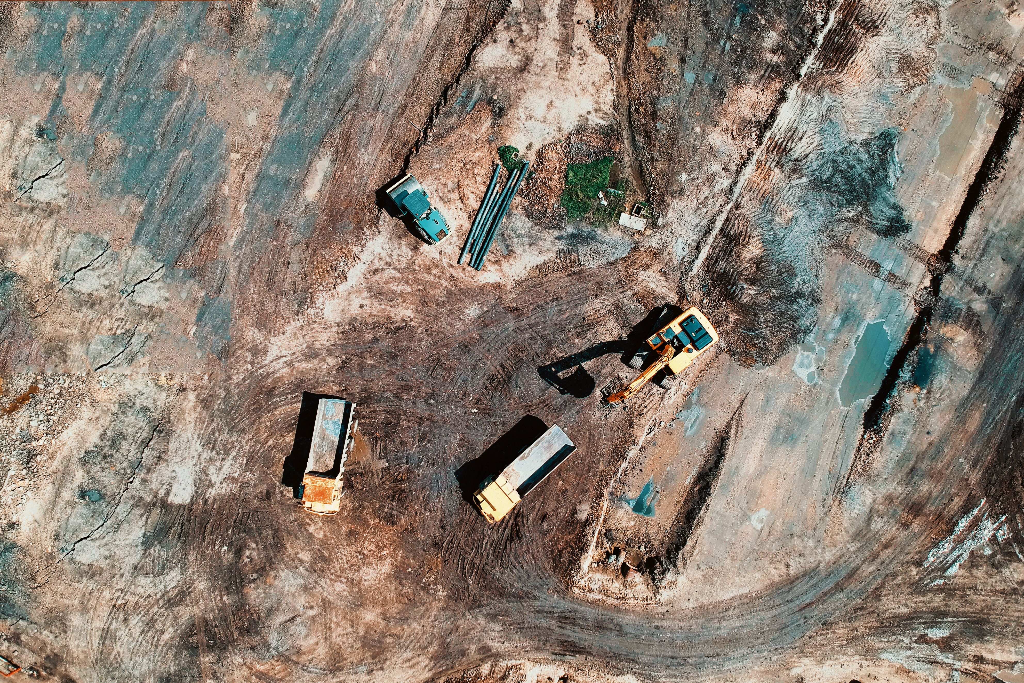Aerial view of a large construction site with trucks and excavation equipment