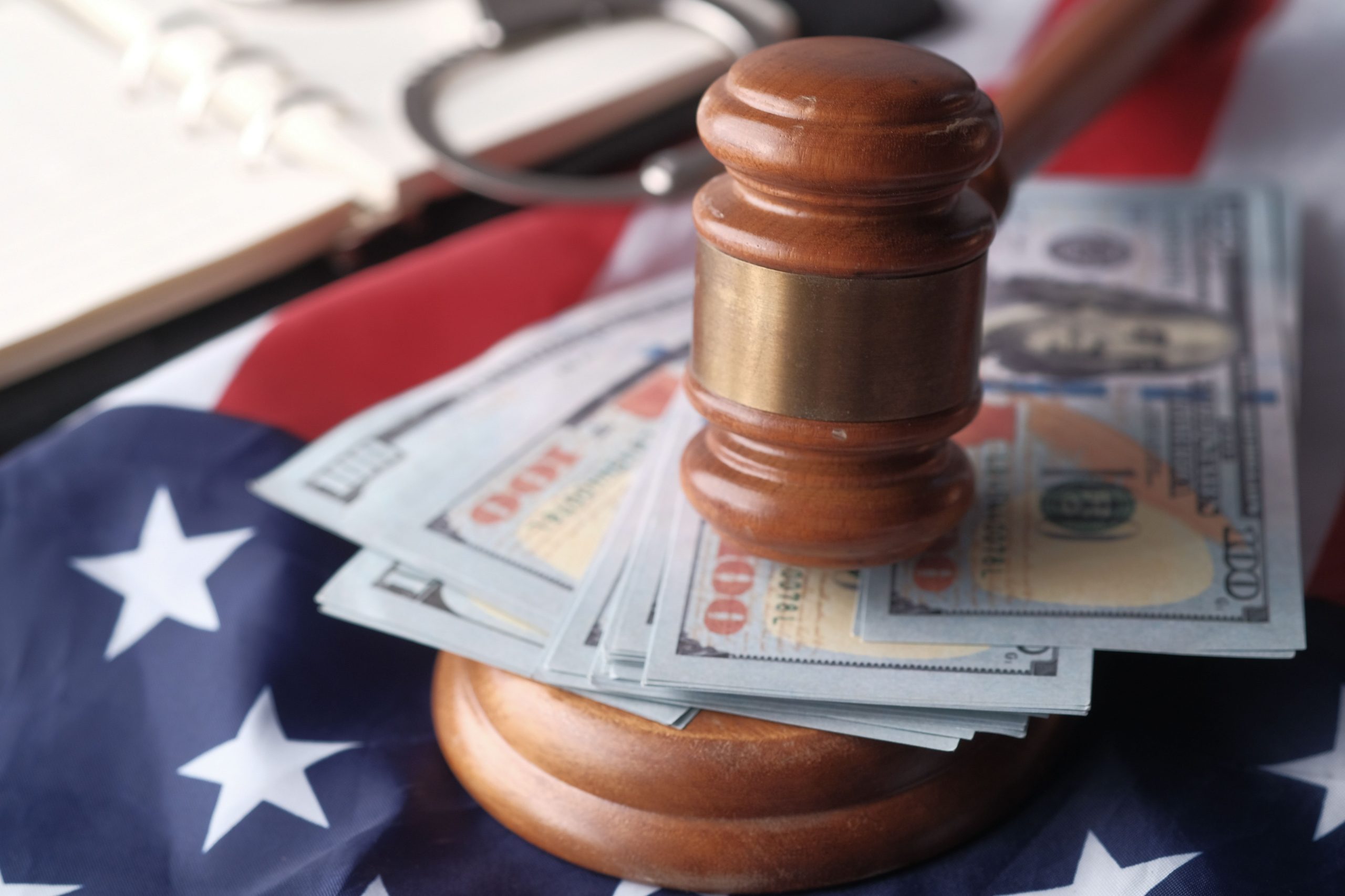 Judge's gavel resting on US dollar bills and an American flag, symbolizing litigation funding and the intersection of law and finance