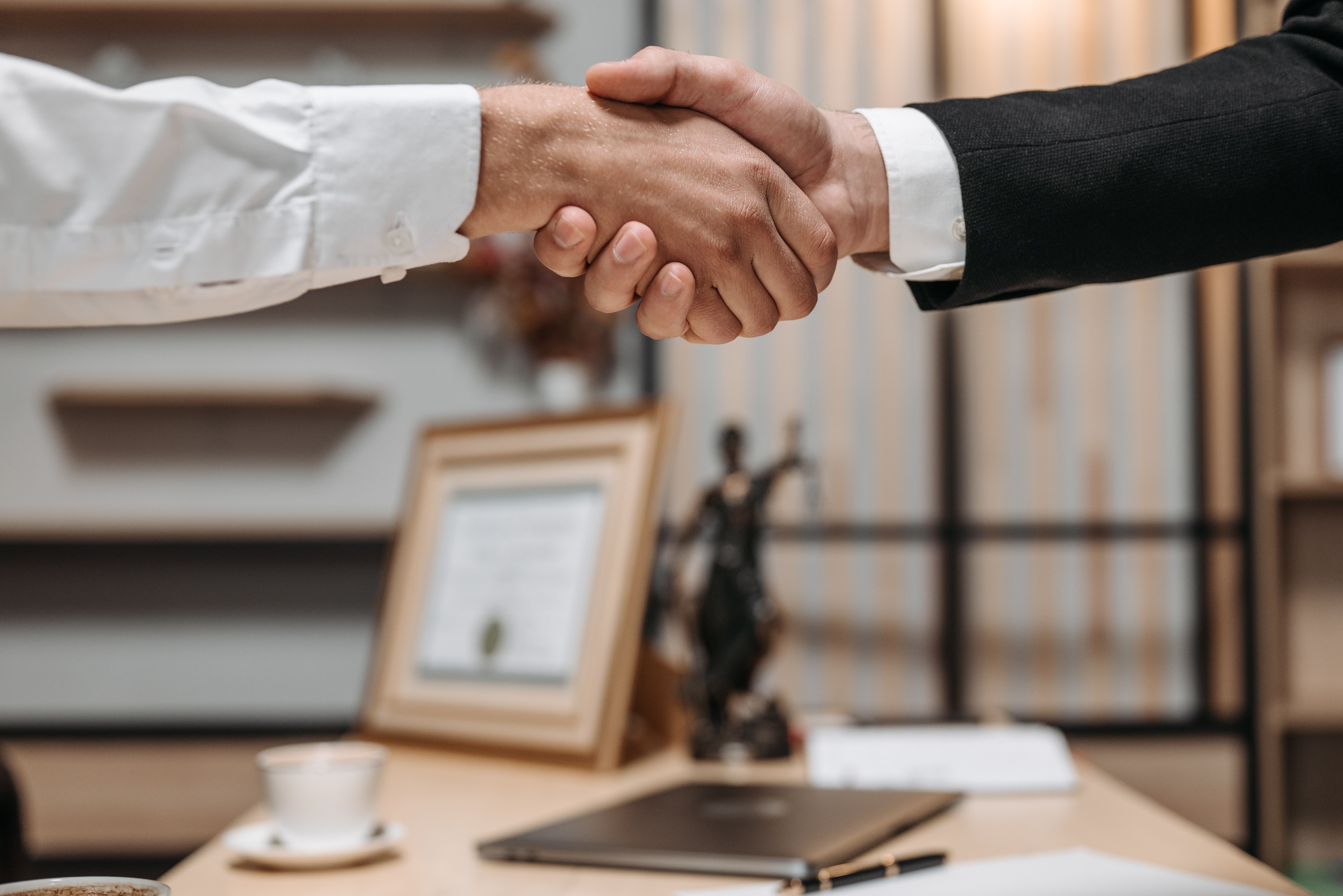Close-up handshake between two professionals, symbolizing a litigation funding partnership agreement
