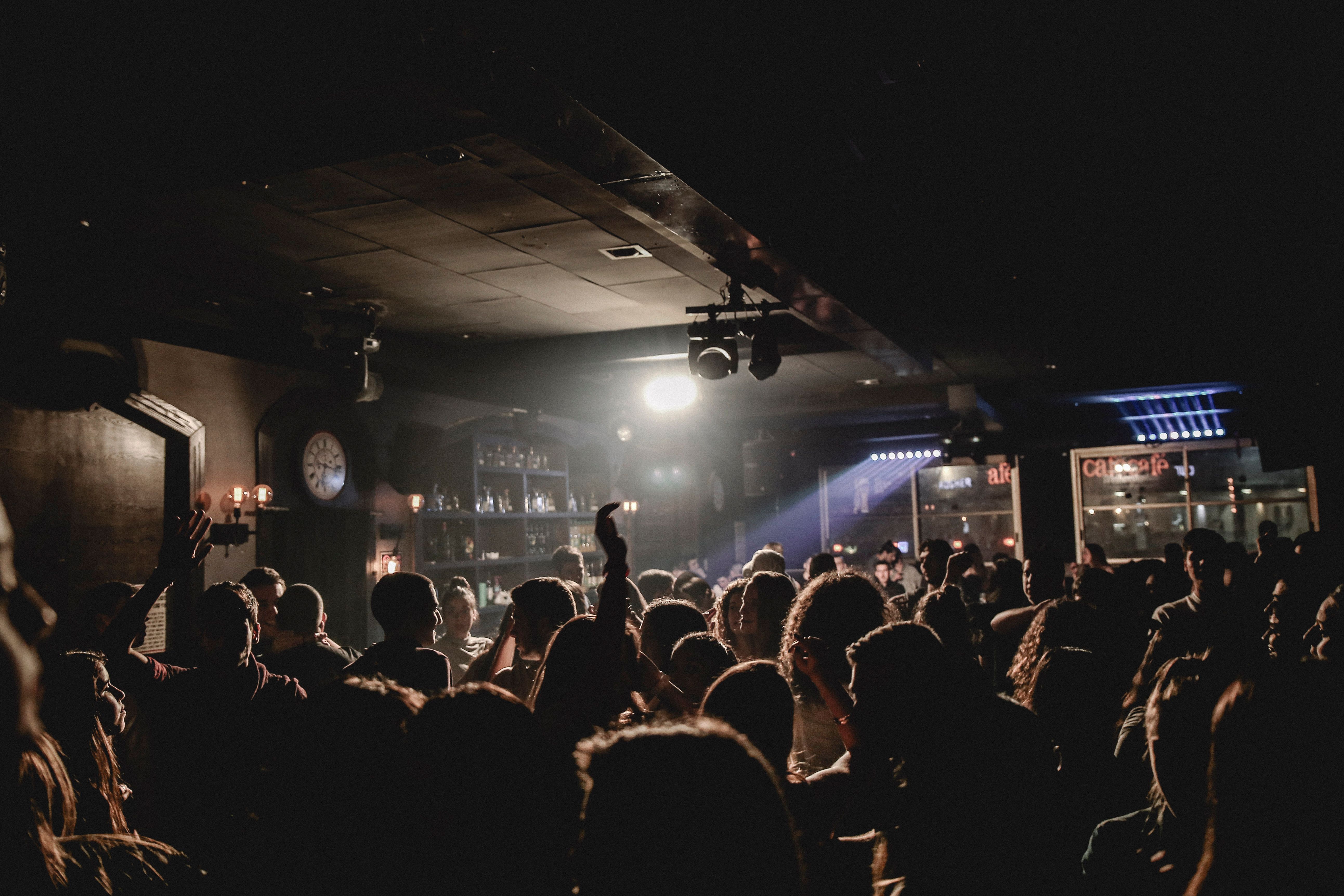 A crowd enjoying a high-energy night at a nightclub dance floor.