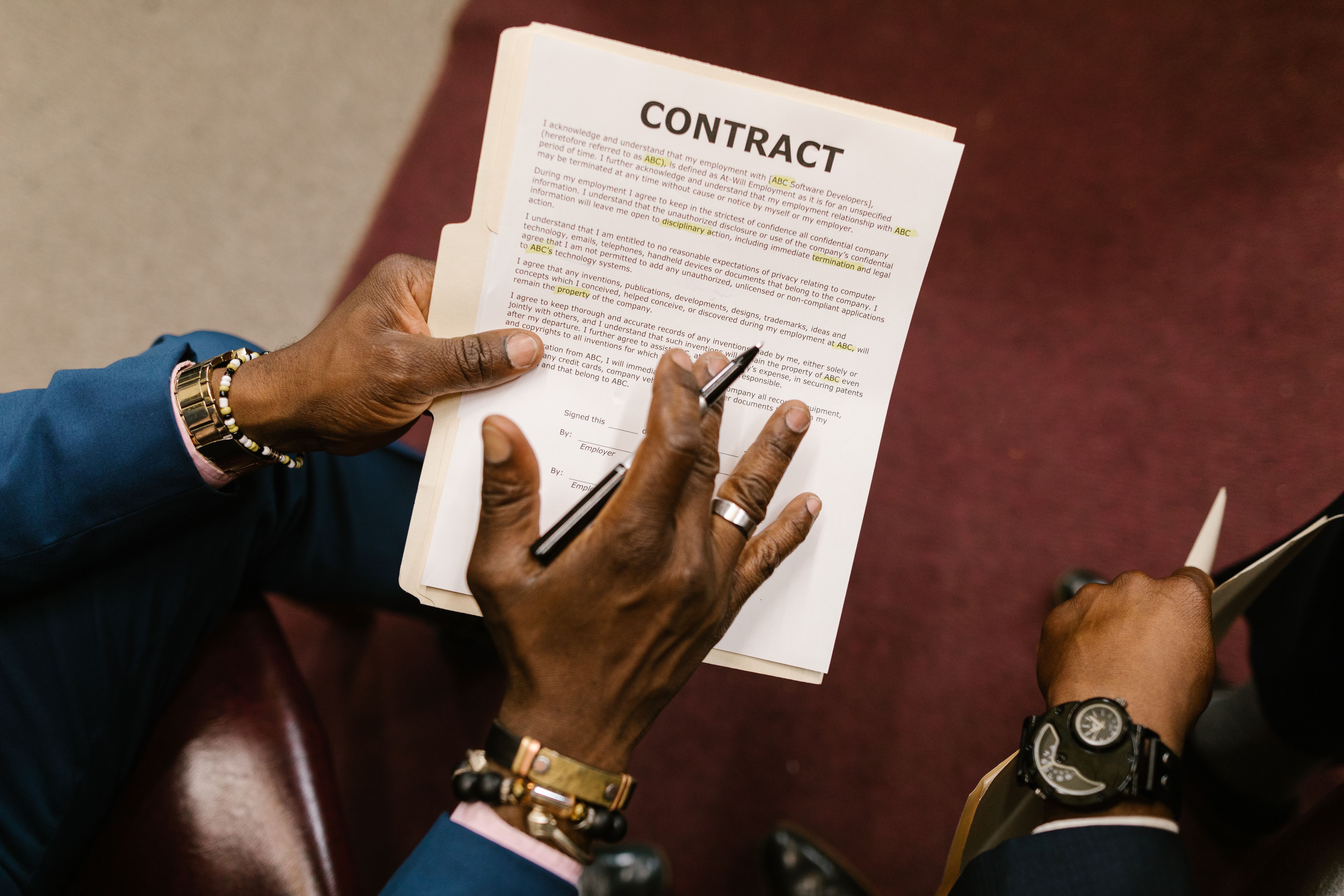 Two businessmen reviewing and signing a contract document, finalizing a litigation finance deal